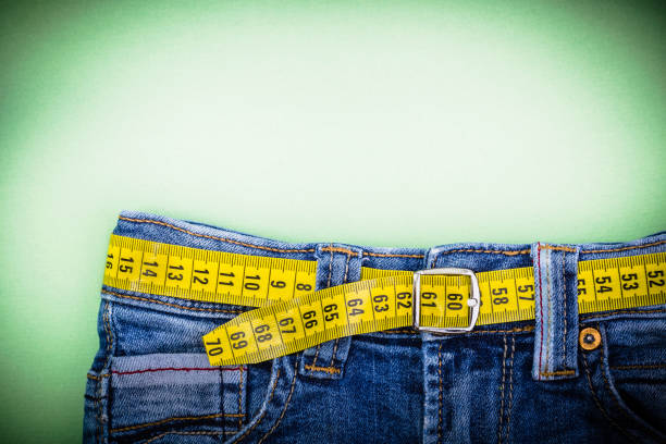 Jeans Jeans and measuring subject for weight loss obesity stock pictures, royalty-free photos & images