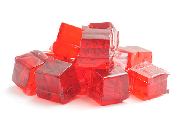 Jelly Cubes A heap of  concentrated Jelly cubes isolated on a white background. gelatin stock pictures, royalty-free photos & images