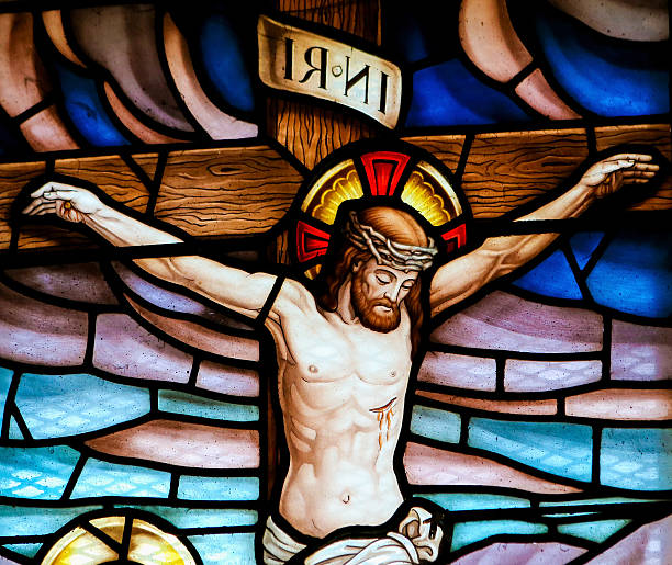 Jesus on the cross - stained glass Stained glass window depicting the Crucifixion in the church of San Andres de Texeido, a famous Galician pilgrimage place in the Rias Altas region. the crucifixion stock pictures, royalty-free photos & images