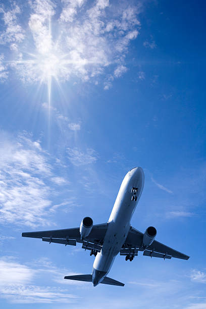 Jet Aeroplane in Bright Summer Sky Vertical stock photo