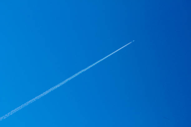 jet airplane trace of an airplane against blue sky vapor trail stock pictures, royalty-free photos & images