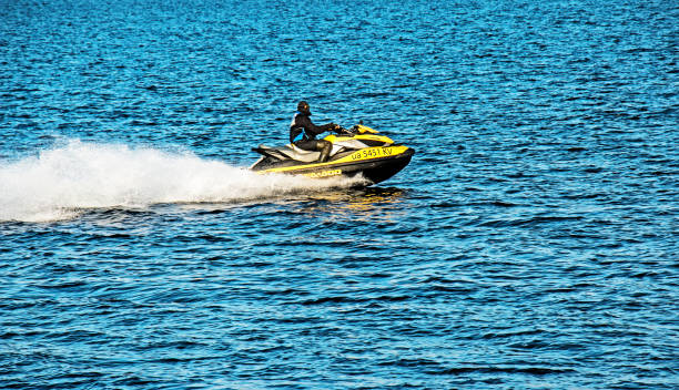 A jet ski with a man racing along the wide Dnieper River in Dnepropetrovsk. stock photo