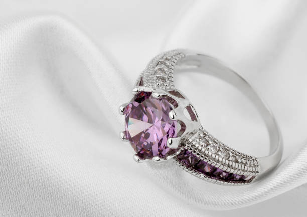 Jewelery ring on white cloth background Jewelery ring on white cloth background amethyst stock pictures, royalty-free photos & images