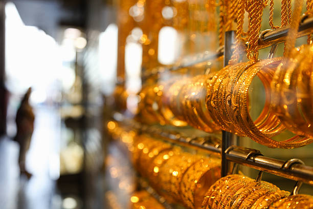 Jewelry at Dubai's Gold Souq Gold bangles in a Dubai gold souk. United Arab Emirates souk stock pictures, royalty-free photos & images