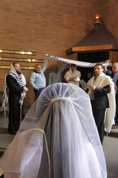Jewish bride on her wedding day Rear view of a Jewish bride before entering under a chupa  (canopy made out of tallit that represents a Jewish home) in a synagog at on her wedding day after Conversion to Judaism. chupah stock pictures, royalty-free photos & images
