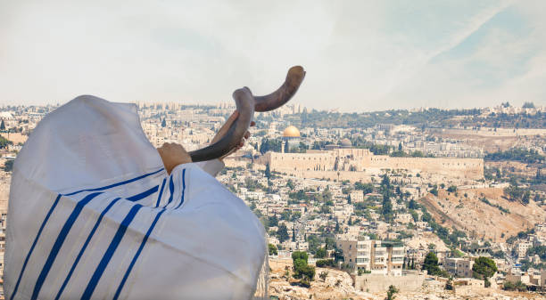 Close up on man Man with Shofar with Jerusalem old city view.
