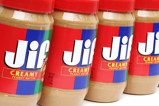 Jif Creamy Peanut Butter West Palm Beach, USA - October 31, 2011: This is an studio product shot showing a row of Jif Creamy Peanut Butter containers. Jif is made by J.M. Smucker Company. jif stock pictures, royalty-free photos & images