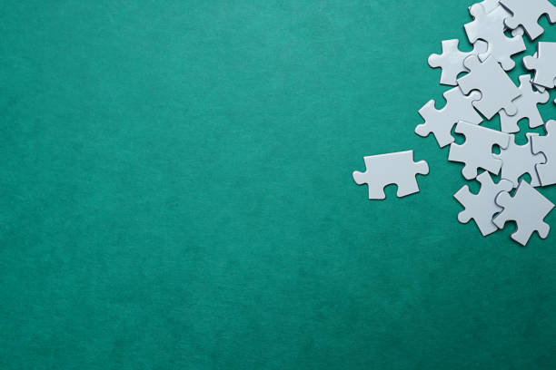 Jigsaw Puzzle pieces on green background stock photo. stock photo