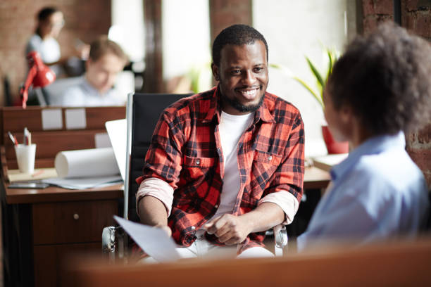 Job interview at office Smiling African businessman in casual clothes conducting the interview with woman at office casual clothing stock pictures, royalty-free photos & images