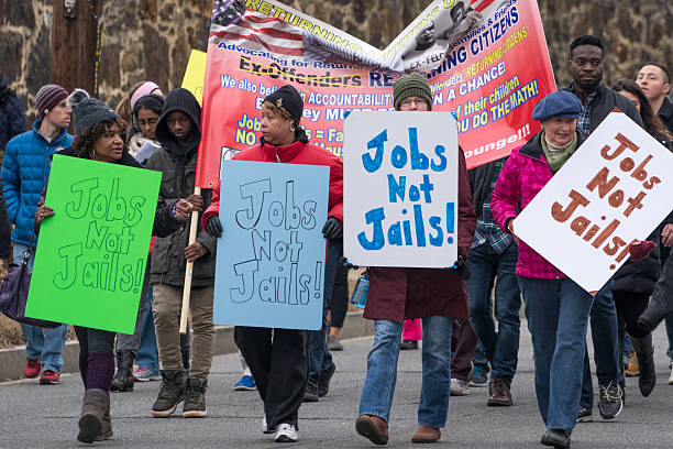 Jobs Not Jails Washington, DC - January 16, 2017: People advocate for jobs during Martin Luther King, Jr. Day Peace Walk and Parade. martin luther king jr day stock pictures, royalty-free photos & images