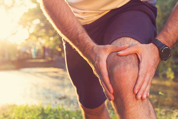 Jogging Injury Always warm-up before jogging or injury occurs... knee stock pictures, royalty-free photos & images