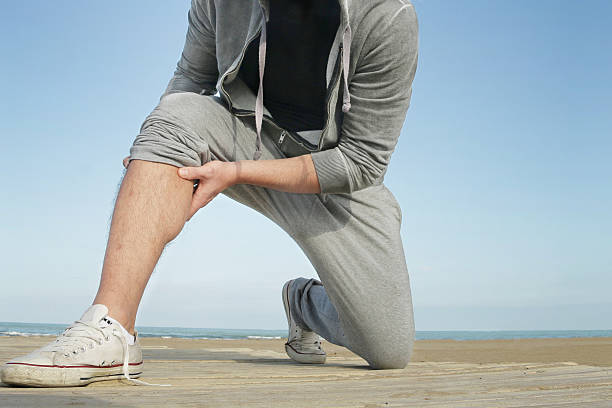 jogging man suffer from cramp or muscle pain stock photo