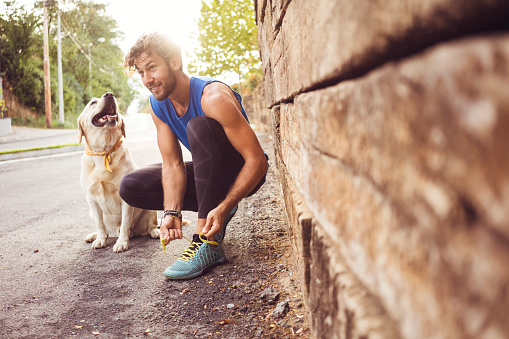 Young man jogging with his dog