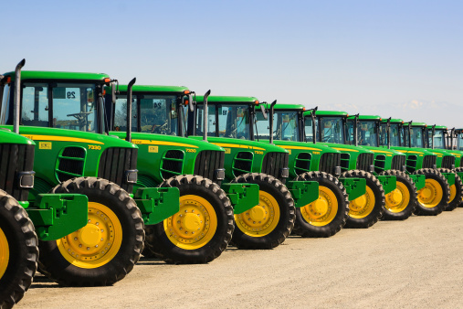 Tulare, CA, USA - February 11, 2011: A row of John Deere farm tractors wait to be sold to the highest bidder at a Ritchie Bros Auction.