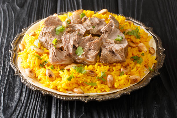 Jordan National Dish Mansaf made of lamb meat Jameed yogurt, rice closeup in the plate. horizontal stock photo