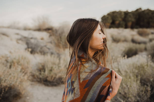 Joyful boho young girl with windy hair in the desert nature Boho woman in the desert nature.  Artistic photo of young hipster traveler girl in gypsy look, vlad model photos stock pictures, royalty-free photos & images