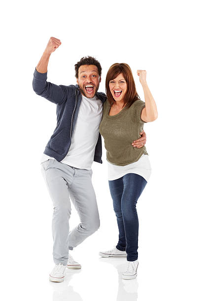 Joyous mature couple celebrating success stock photo