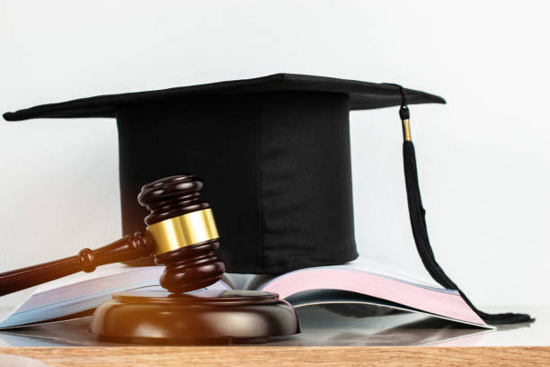 Judge gavel school lawyer on open book in library with diploma hat on wooden desk.Concept of Education Graduation study international legal rights, jurisprudence laws in university stock photo