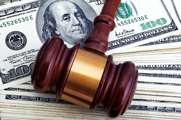 Judgement Day Gavel over hundred dollar bills. Financial settlement. US DOLLAR stock pictures, royalty-free photos & images