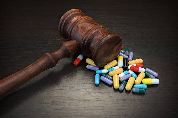 Judges Gavel And Medication On Black Wood Grunge Background Judges Gavel And Medication On Black Wood Grunge Background, Top View, Close-Up. sentencing stock pictures, royalty-free photos & images
