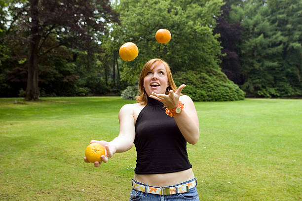 juggling oranges 2 stock photo