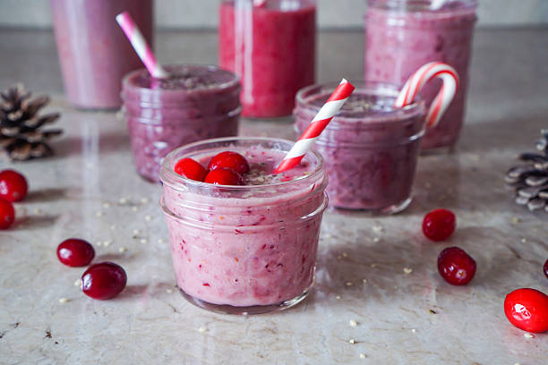 Juicy berry smoothies in glass jars on marble background. stock photo
