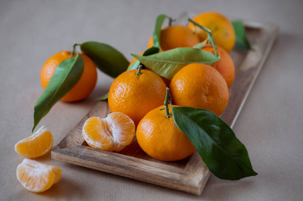 Juicy mandarins with fresh green leaves stock photo