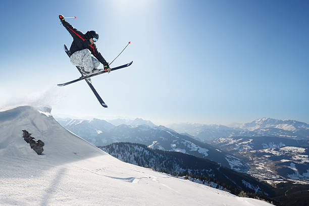 Jumping skier on a snowy mountain stock photo