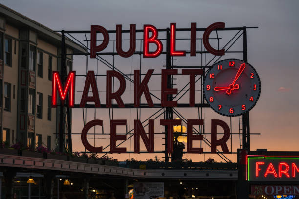 Seattle, USA – Jun 20, 2020: Late in the day the Pike Place Market sign illuminated during a vivid sunset on the weekend of Juneteenth.