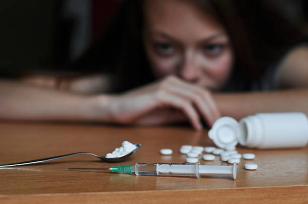 Junkie girl Junkie girl looking at drugs heroin stock pictures, royalty-free photos & images