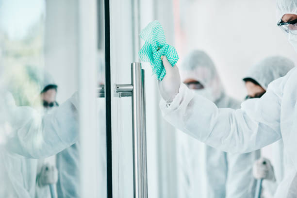 Just because it's invisible doesn't mean it's not there Shot of healthcare workers wearing hazmat suits and sanitising a room during an outbreak contamination photos stock pictures, royalty-free photos & images