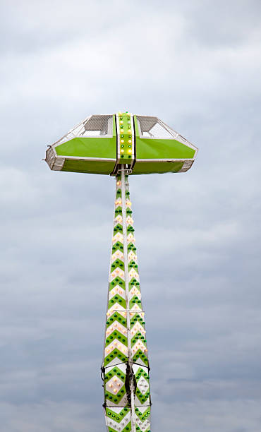 Just Before the Fall Circular-turning, zero gravity-propelled carnival amusement ride. It's not the Space Needle, just a dumb ride that'll make you hurl. Vertical. zero gravity carnival ride stock pictures, royalty-free photos & images