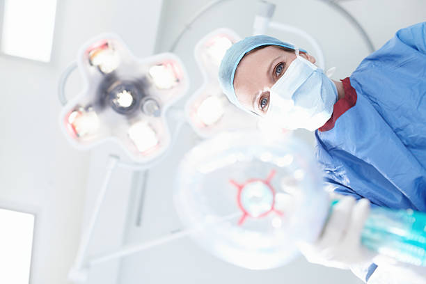 Just breathe in and out very slowly Patient's view of a medical surgeon/nurse putting them under a general anaesthetic anesthetic stock pictures, royalty-free photos & images