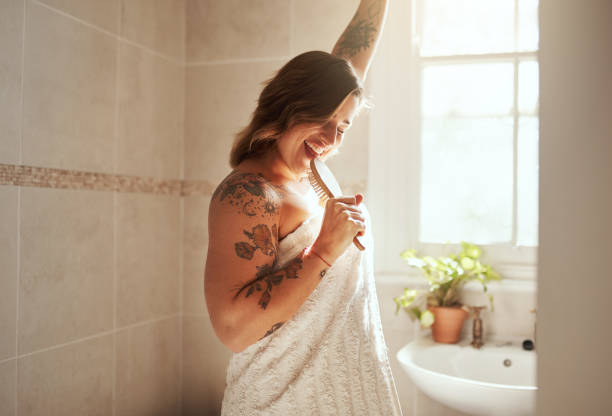 Just like the birds, welcome the day with a song Shot of an attractive young woman singing while going through her morning beauty routine at home beautiful voluptuous women stock pictures, royalty-free photos & images