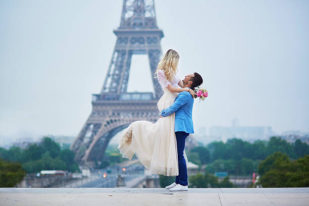 Just married couple in Paris, France Just married couple in Paris, France. Beautiful young bride and groom near the Eiffel tower. Romantic wedding in Paris concept eiffel tower paris photos stock pictures, royalty-free photos & images