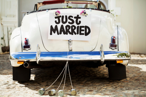 just married sign and cans attached to cars trunk