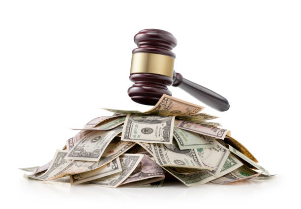 Justice and money. Judge gavel on a pile of dollar bills. stock photo