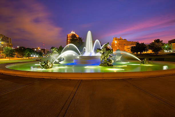 Kansas City Fountains The J.C Nichols Memorial Fountain over looking the skyline of Kansas City early in the morning. kansas city missouri stock pictures, royalty-free photos & images