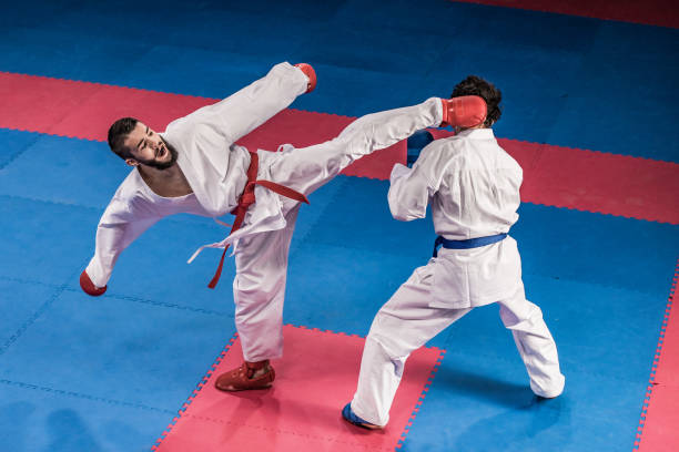 Karate players competing during the match Male karate players fighting during the competition. karate stock pictures, royalty-free photos & images