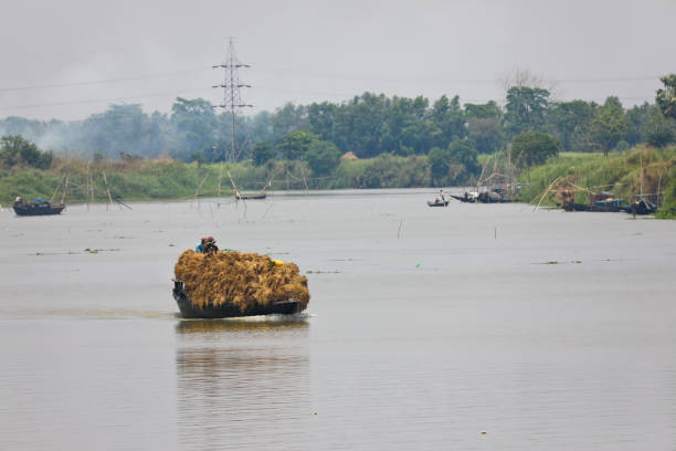 Katwa India West Bengal river Ganges Boat transporting harvest and daily chorus stock photo
