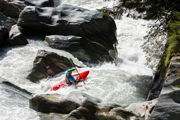 Kayaker in white water stock photo