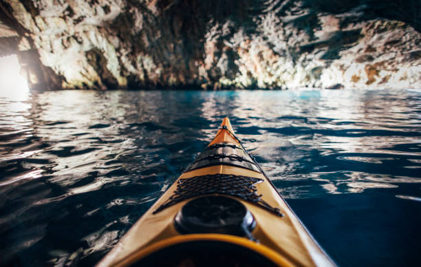 Kayaking and caving at the same time stock photo