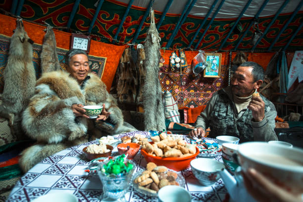 Kazakhs family of hunters with hunting golden eagles. stock photo