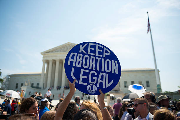Keep abortion legal sign at Supreme Court Washington DC, USA - June 27, 2016: Pro-choice supporters celebrate in front of the U.S. Supreme Court after the court, in a 5-3 ruling, struck down a Texas abortion access law. abortion protest stock pictures, royalty-free photos & images