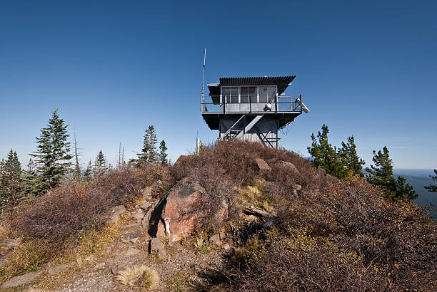 Kendrick Mountain Fire Lookout Kendrick Peak, at 10,425 feet above sea level, is one of the highest mountains in Arizona. It’s part of the San Francisco Volcanic Field. The Kendrick Peak fire lookout, built in the early 1900’s is staffed by the Forest Service during the week and by volunteers on the weekends. Kendrick Peak is in the Kendrick Peak Wilderness near Flagstaff, Arizona, USA. jeff goulden fire lookout stock pictures, royalty-free photos & images