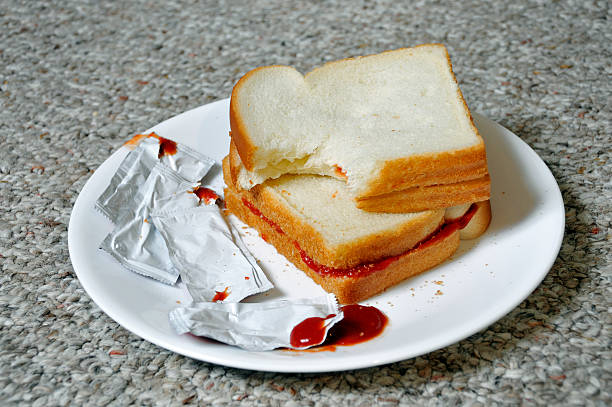 Ketchup Sandwiches, Not on a Table "A sign of leaner times, ketchup sandwiches made of white bread and free ketchup packets courtesy of the local fast food dive. Do take note that this fine meal isn't shown on a table, because there isn't one!" mike cherim stock pictures, royalty-free photos & images