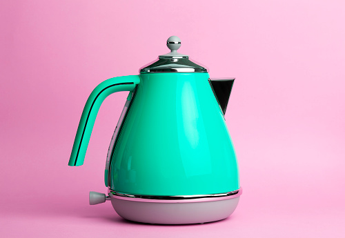 Kettle Background. Electric vintage retro kettle on a colored pink background. Lifestyle and design concept.