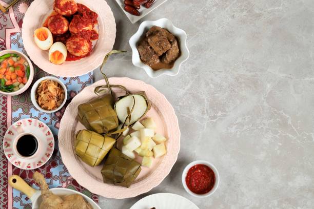 Ketupat Lebaran. Traditional Celebratory Dish of Rice Cake or Ketupat with Various Side Dishes stock photo