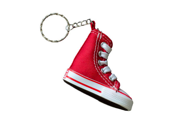 Key chain with mini red basketball shoe on white background stock photo