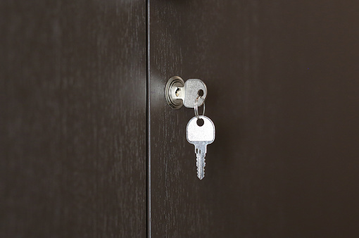Key In Keyhole On Wooden Cabinet Key In Lock Stock Photo
